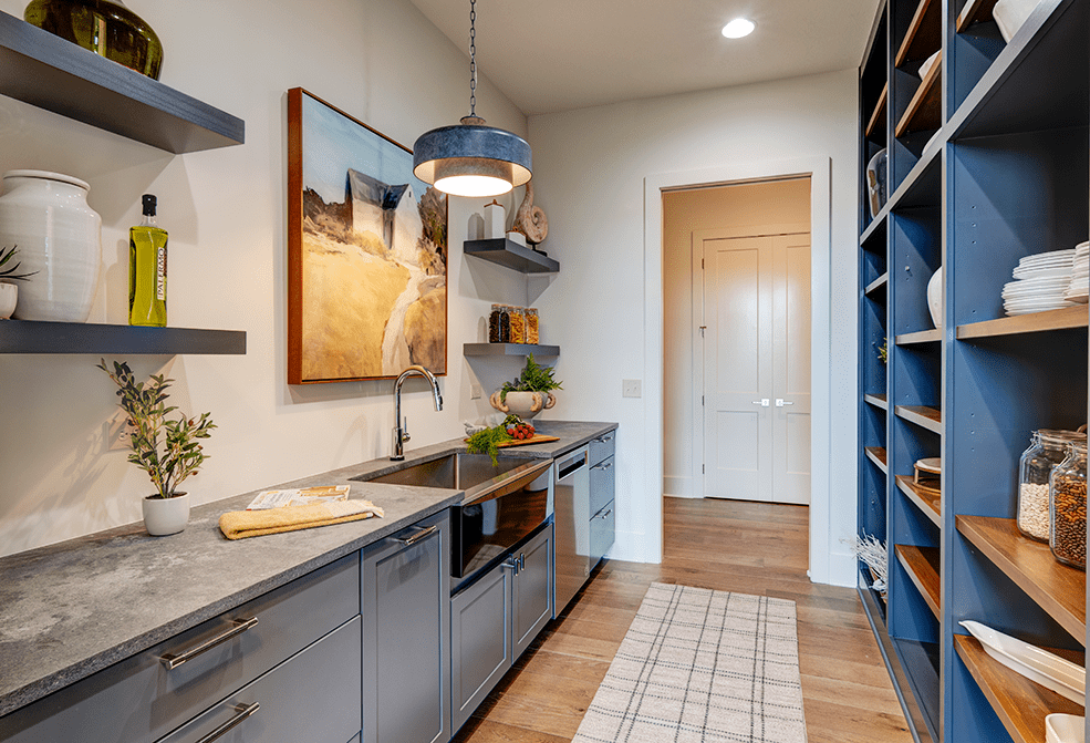 A kitchen with blue cabinets and a sink.