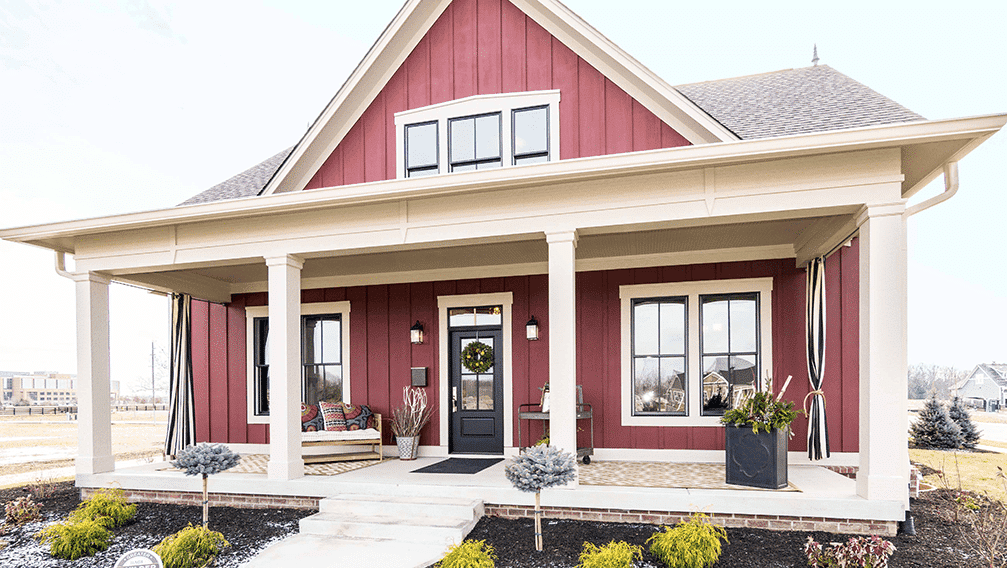 A red and white home with a porch.