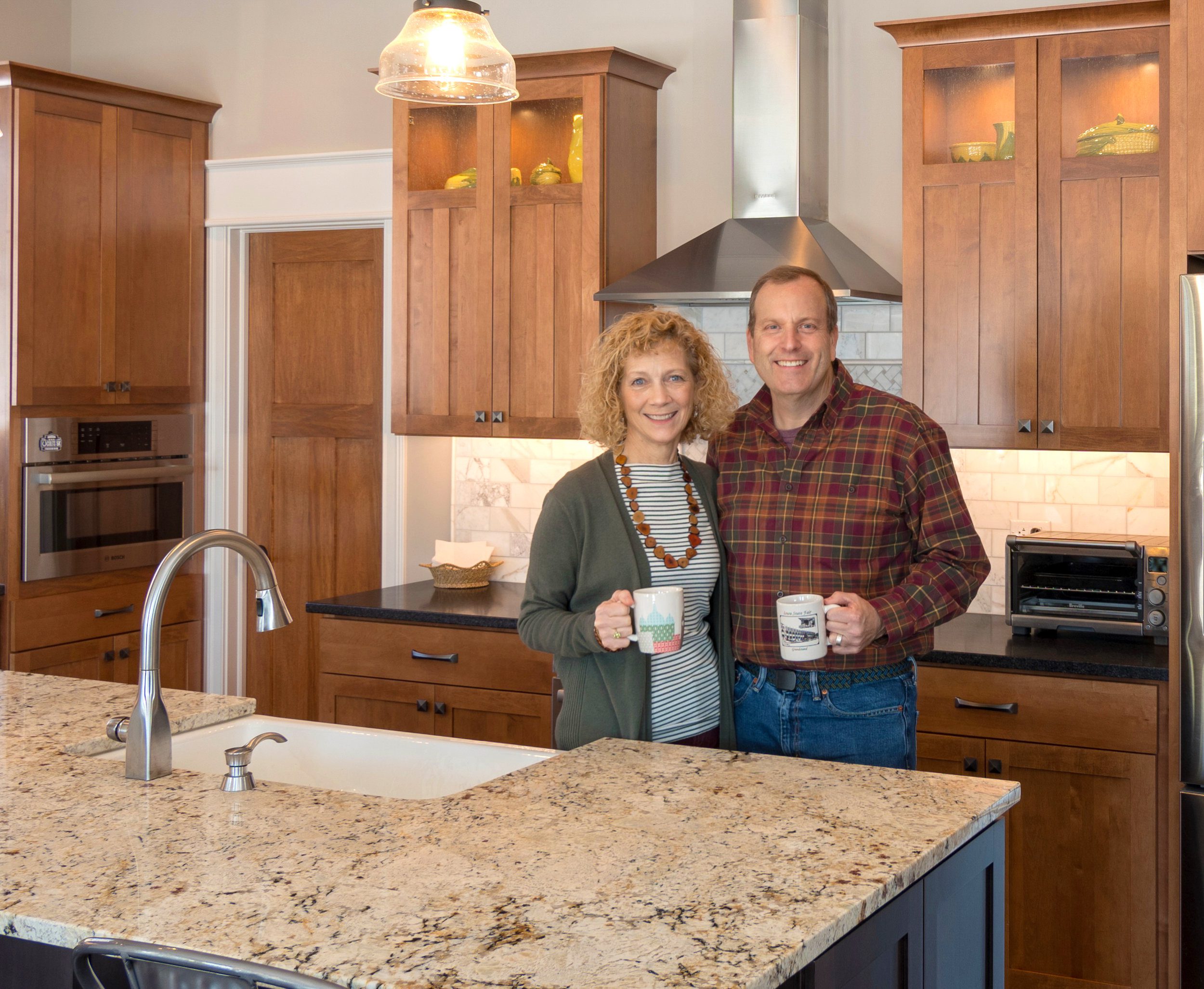 A man and woman standing in a luxury custom kitchen in Westfield Indiana.