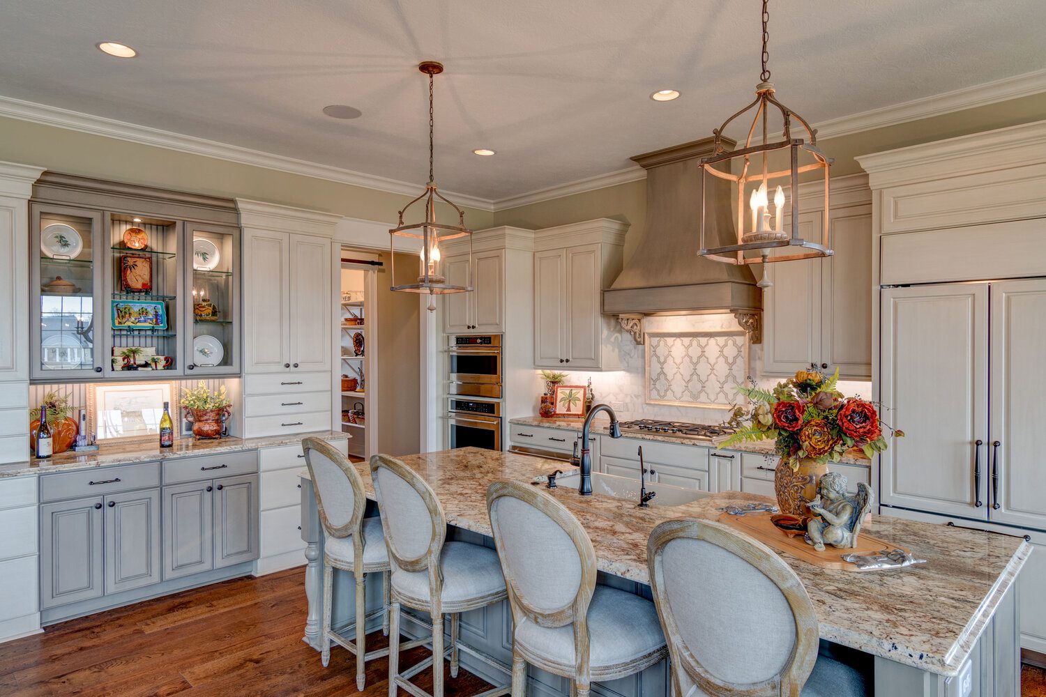 A spacious kitchen featuring a center island and bar stools, perfect for gatherings.