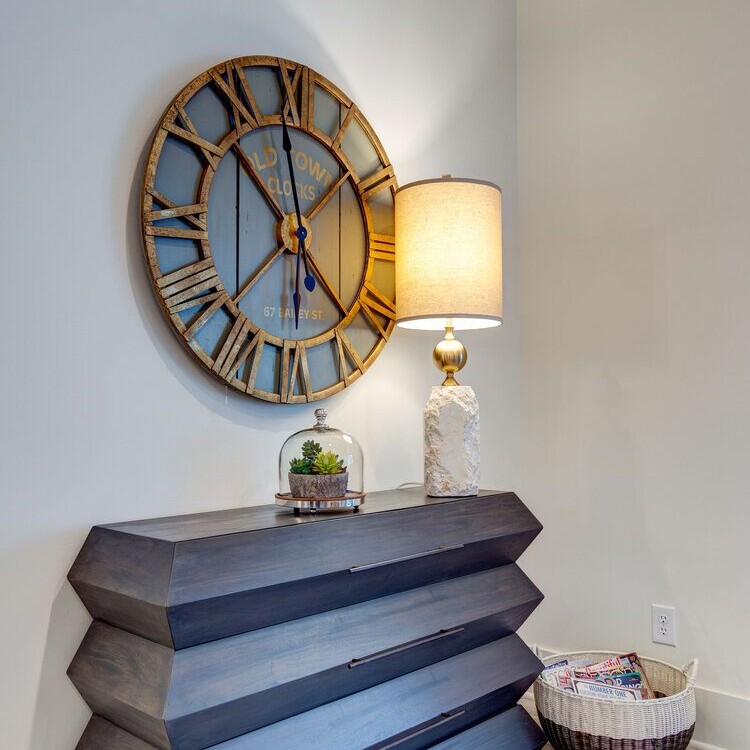 A hallway dresser with a clock on it, custom-built by a home builder in Carmel, Indiana.