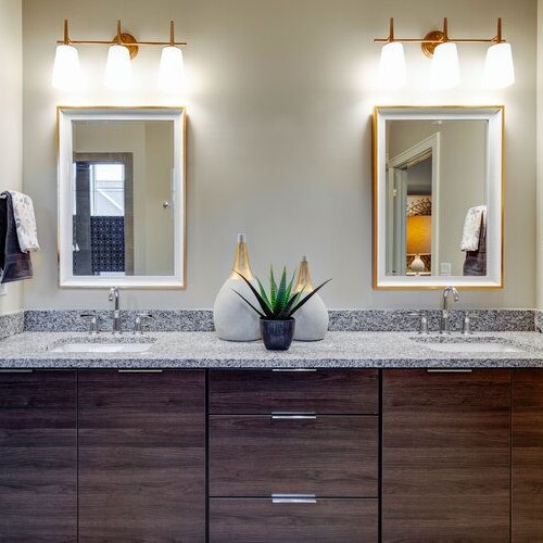 A bathroom with two sinks and two mirrors in a new home construction in Carmel, Indiana.