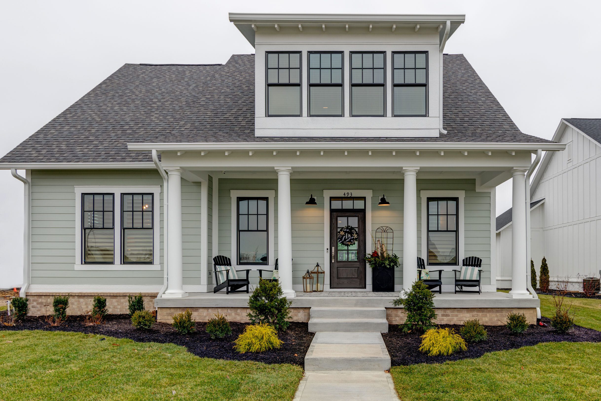The exterior of a Custom Home Builder Indianapolis Indiana with a porch and porches.