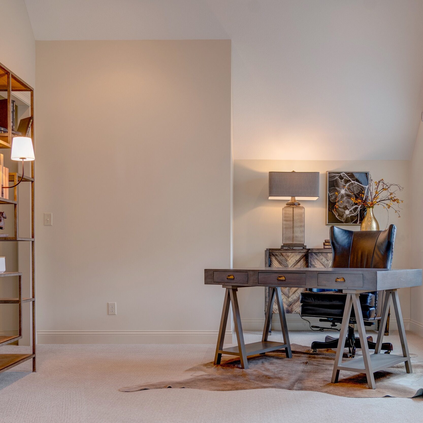 A home office featuring a desk and bookshelves, perfect for remote work or studying.