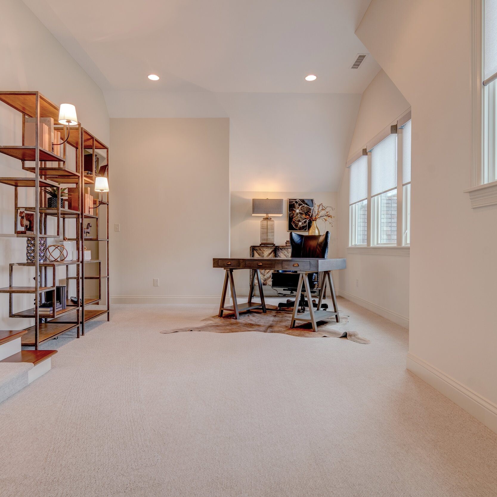 A hallway with bookshelves and a bookcase featuring new home construction in Indianapolis, Indiana.