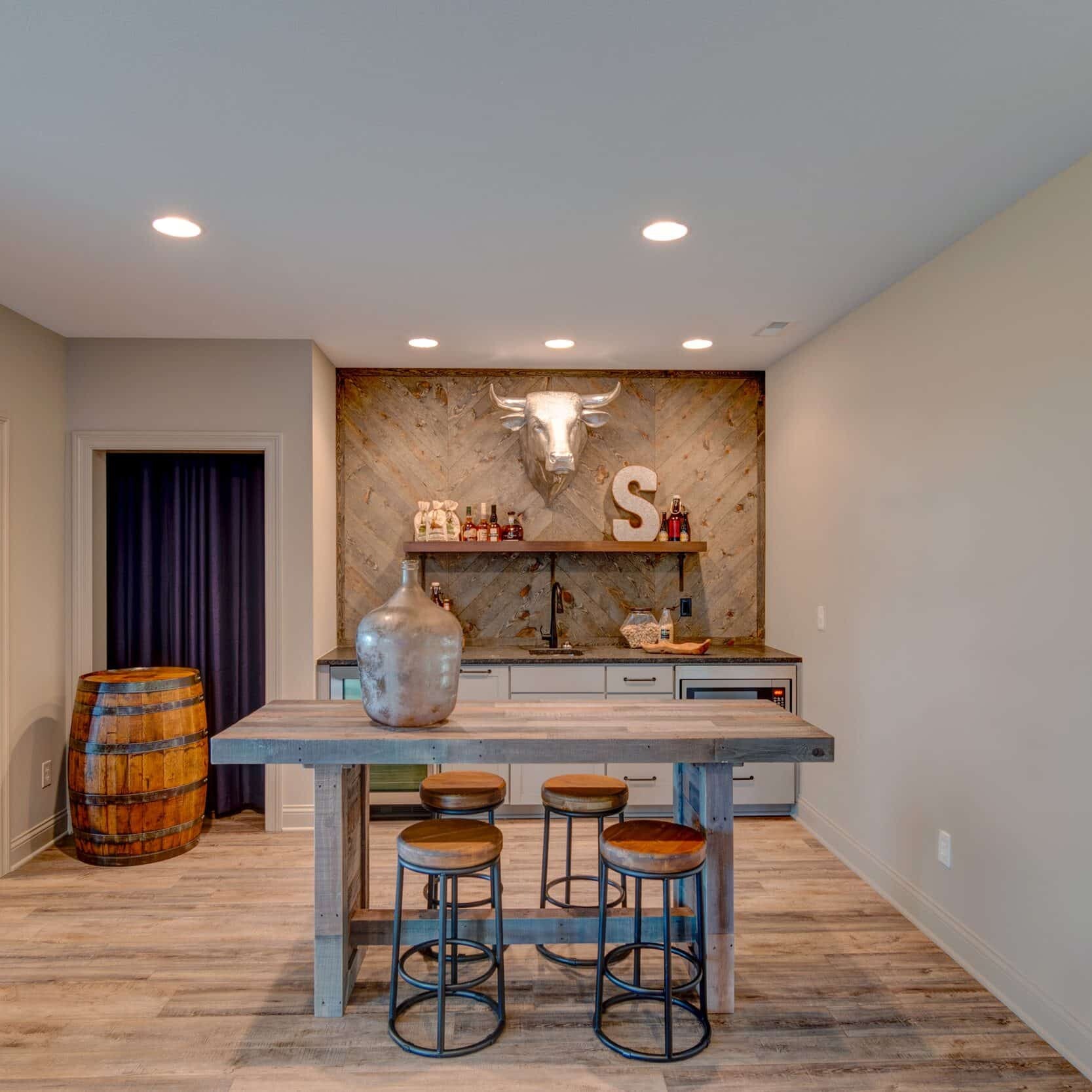 A custom home bar with stools and a wooden floor in a newly constructed home in Indianapolis, Indiana.