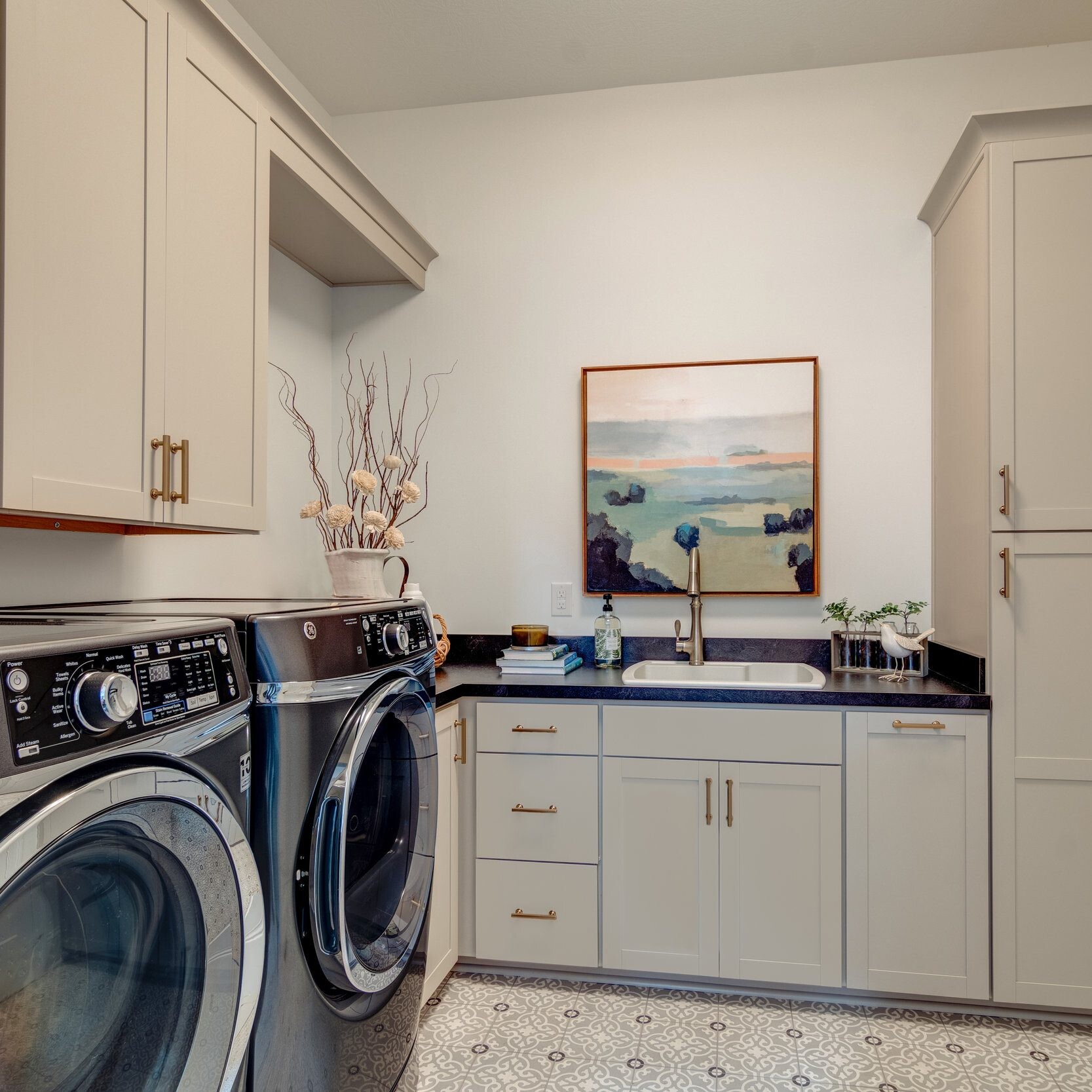 A laundry room with a washer and dryer in a new home construction.