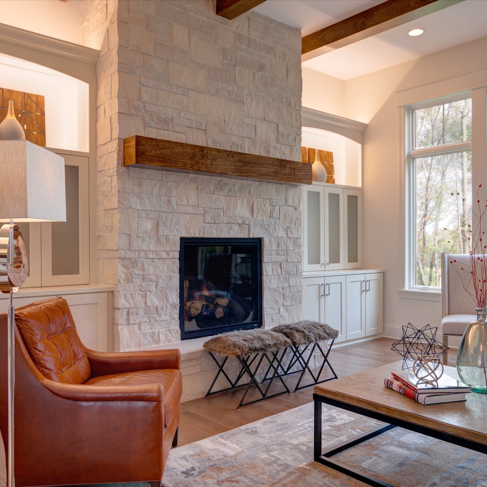 A custom-built living room with a stone fireplace, located in Westfield, Indiana.