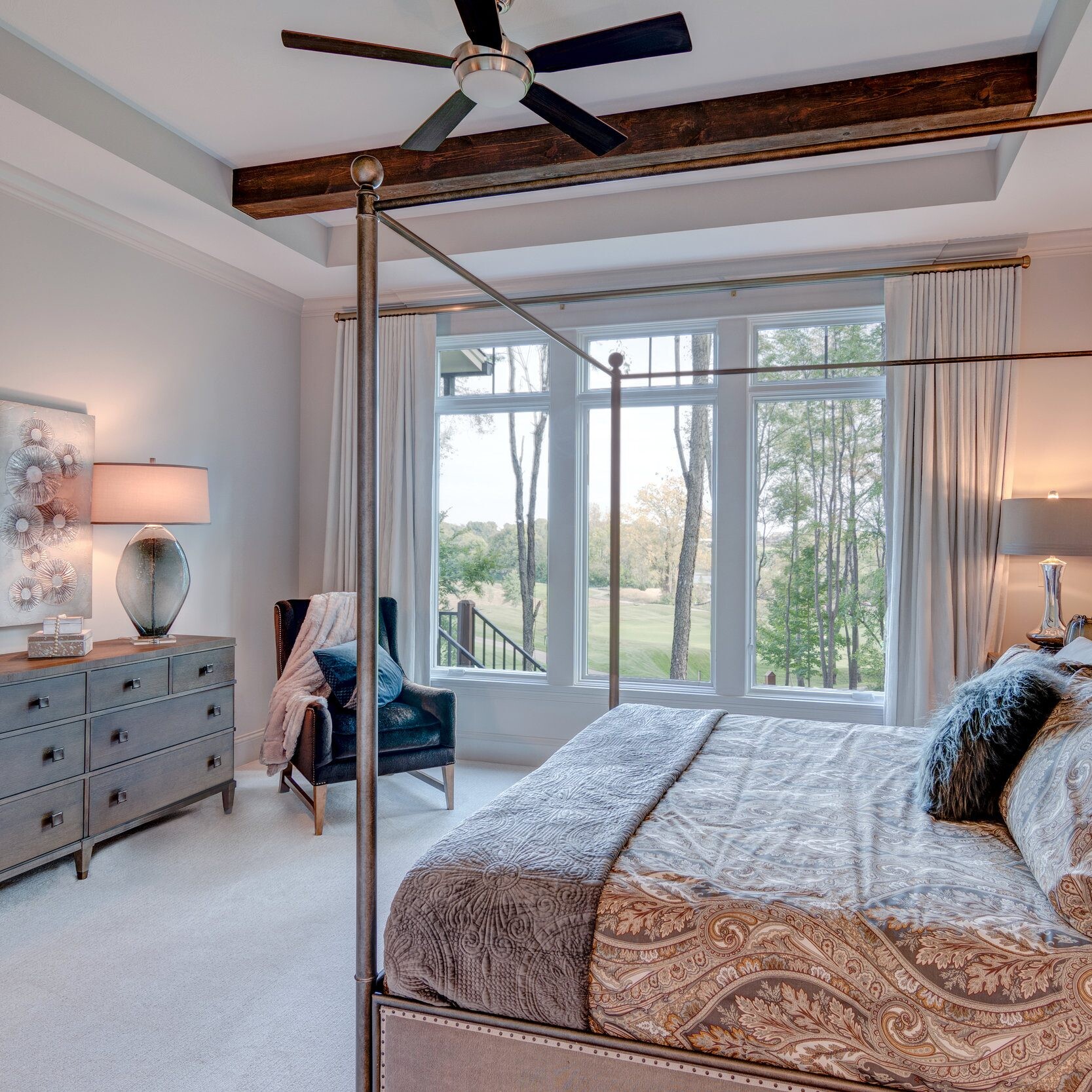 A bedroom with a four poster bed and ceiling fan in a new home construction in Indianapolis, Indiana.