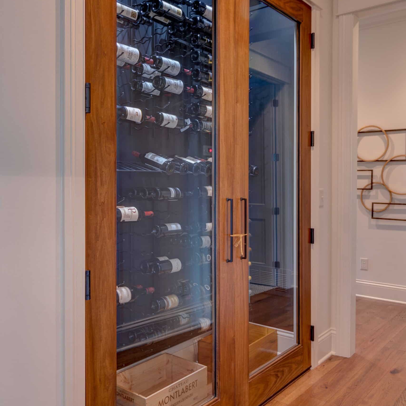 A wine cellar with glass doors in a home for sale in Westfield, Indiana.