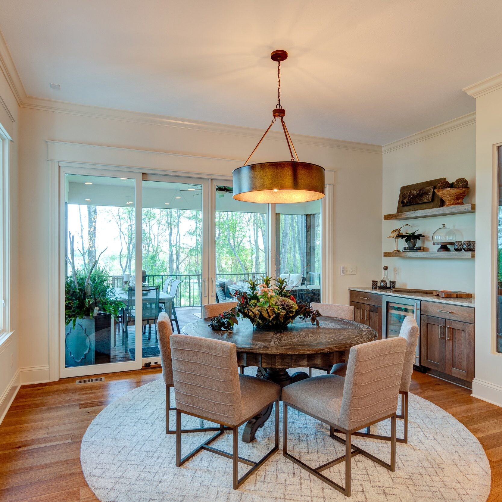 A dining room with a round table and chairs in a new home construction.