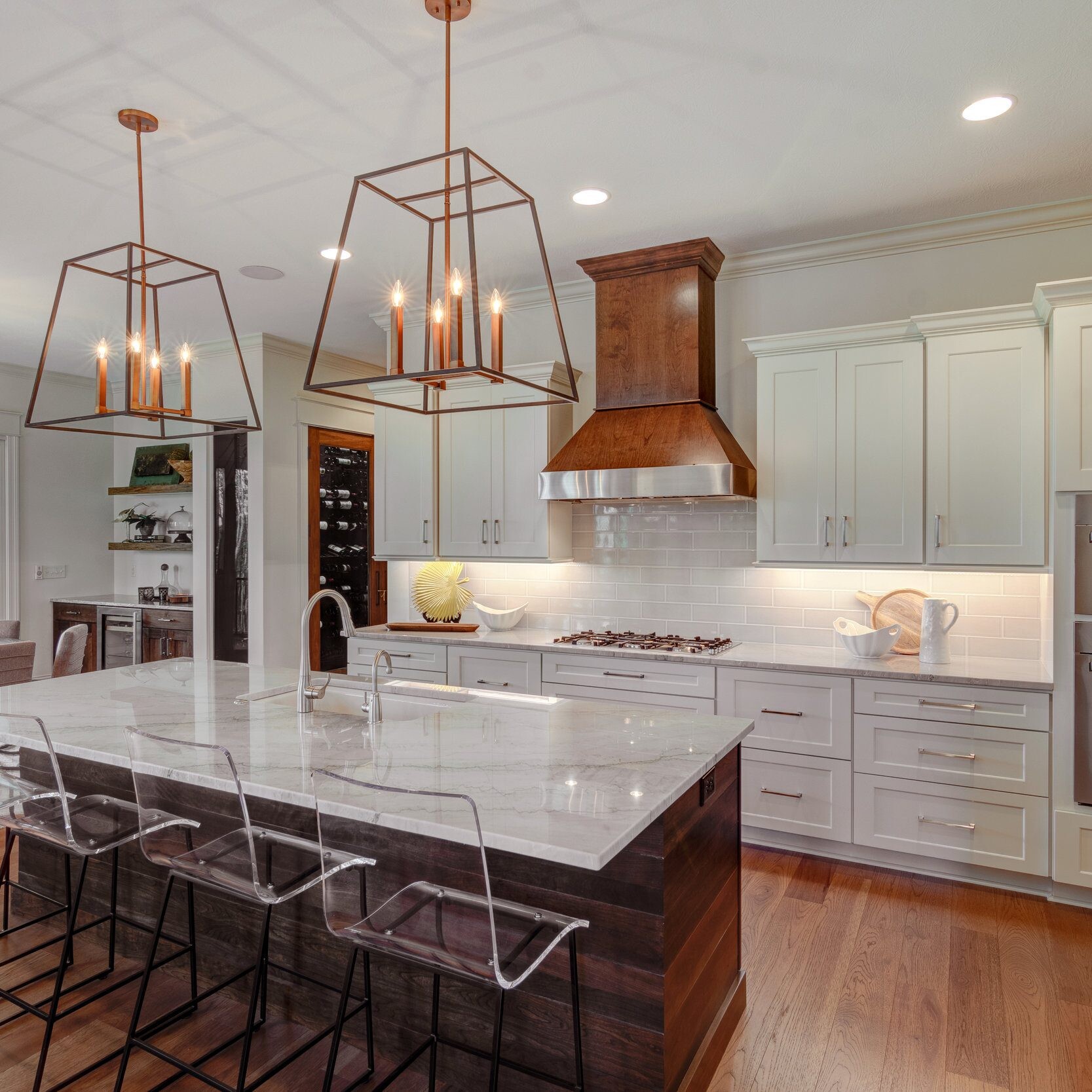 A newly constructed kitchen featuring a spacious island and stylish bar stools.