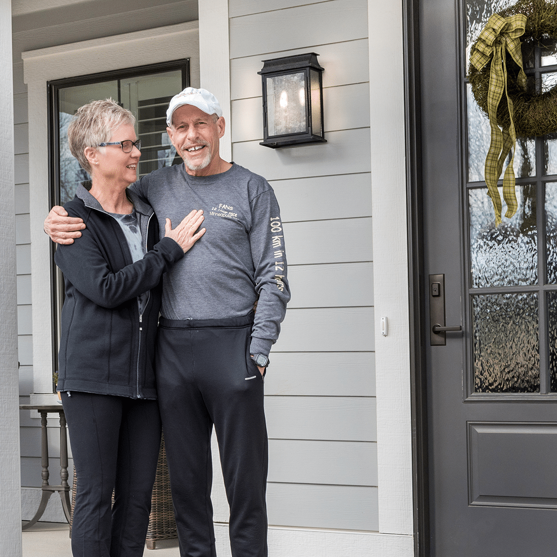 A couple standing on the front porch of their new Indianapolis custom home.
