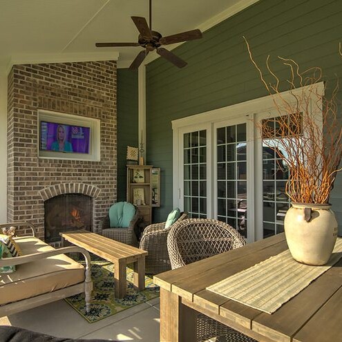 A patio with furniture and a fireplace, perfect for enjoying the outdoors in luxury.