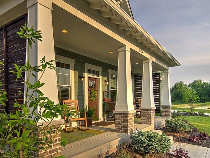 A cozy front porch of a home with a rocking chair, perfect for relaxation and enjoying the pleasant surroundings.