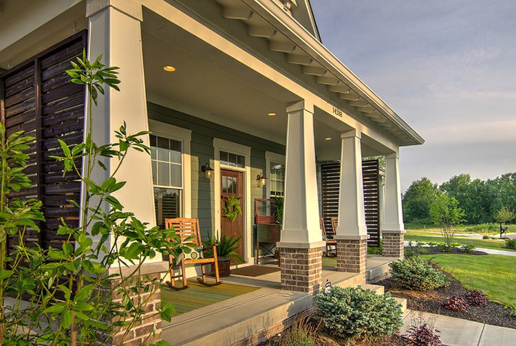A cozy front porch of a home with a rocking chair, perfect for relaxation and enjoying the pleasant surroundings.