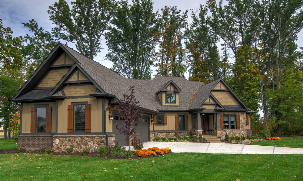 A custom home with a large front porch and a large driveway in Carmel, Indiana.