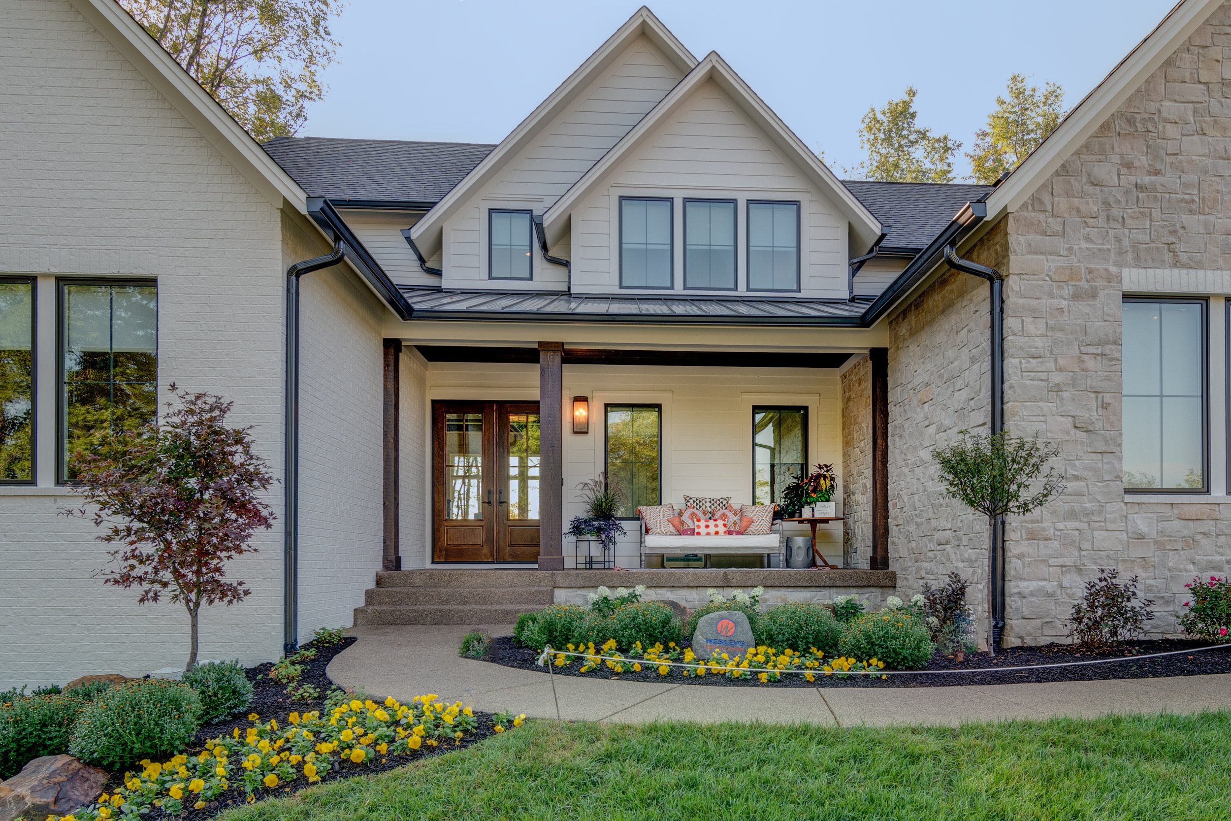 A custom home with a front porch and landscaping for sale in Carmel Indiana.