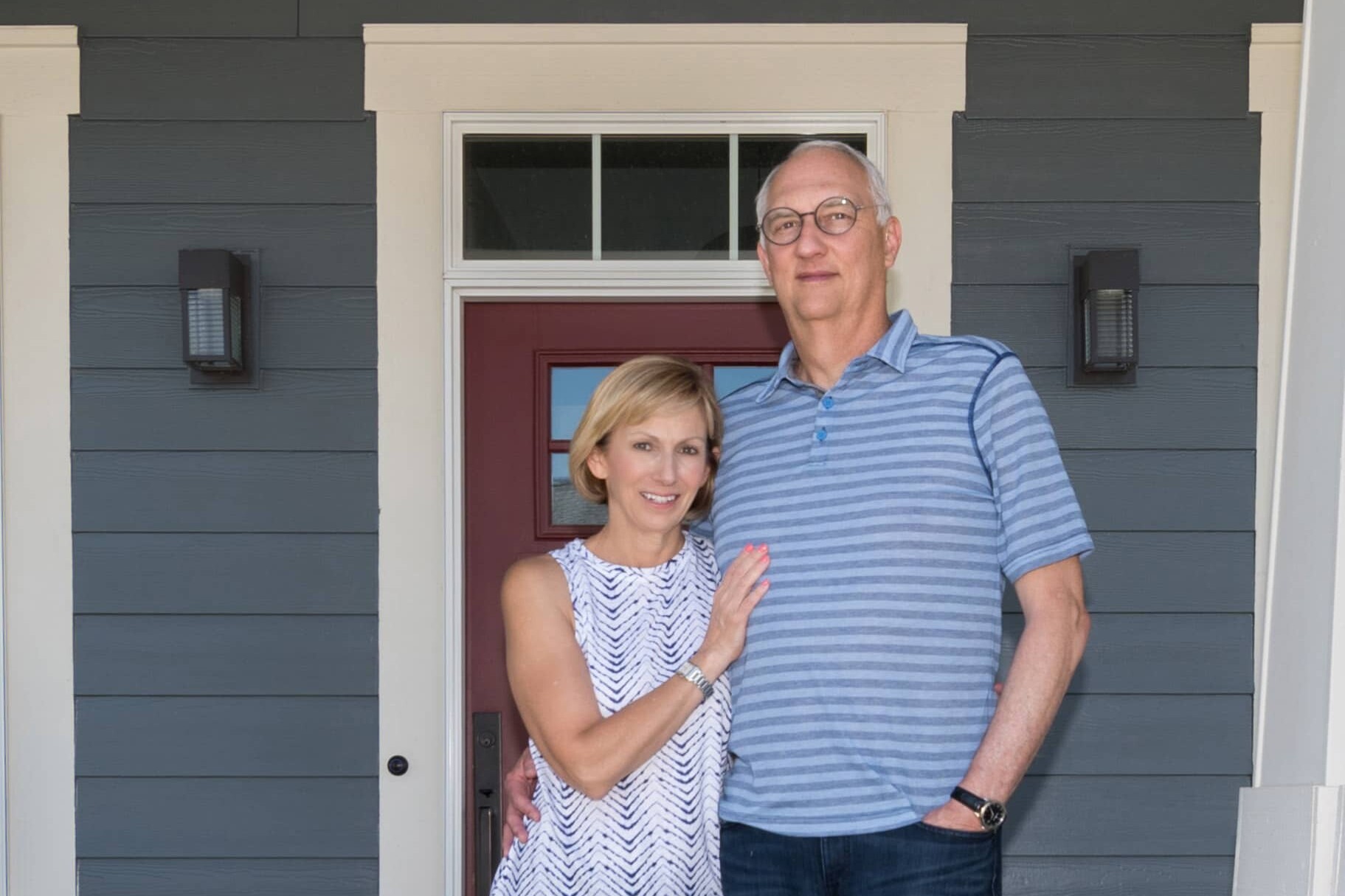 An older couple standing in front of their Indianapolis custom home.