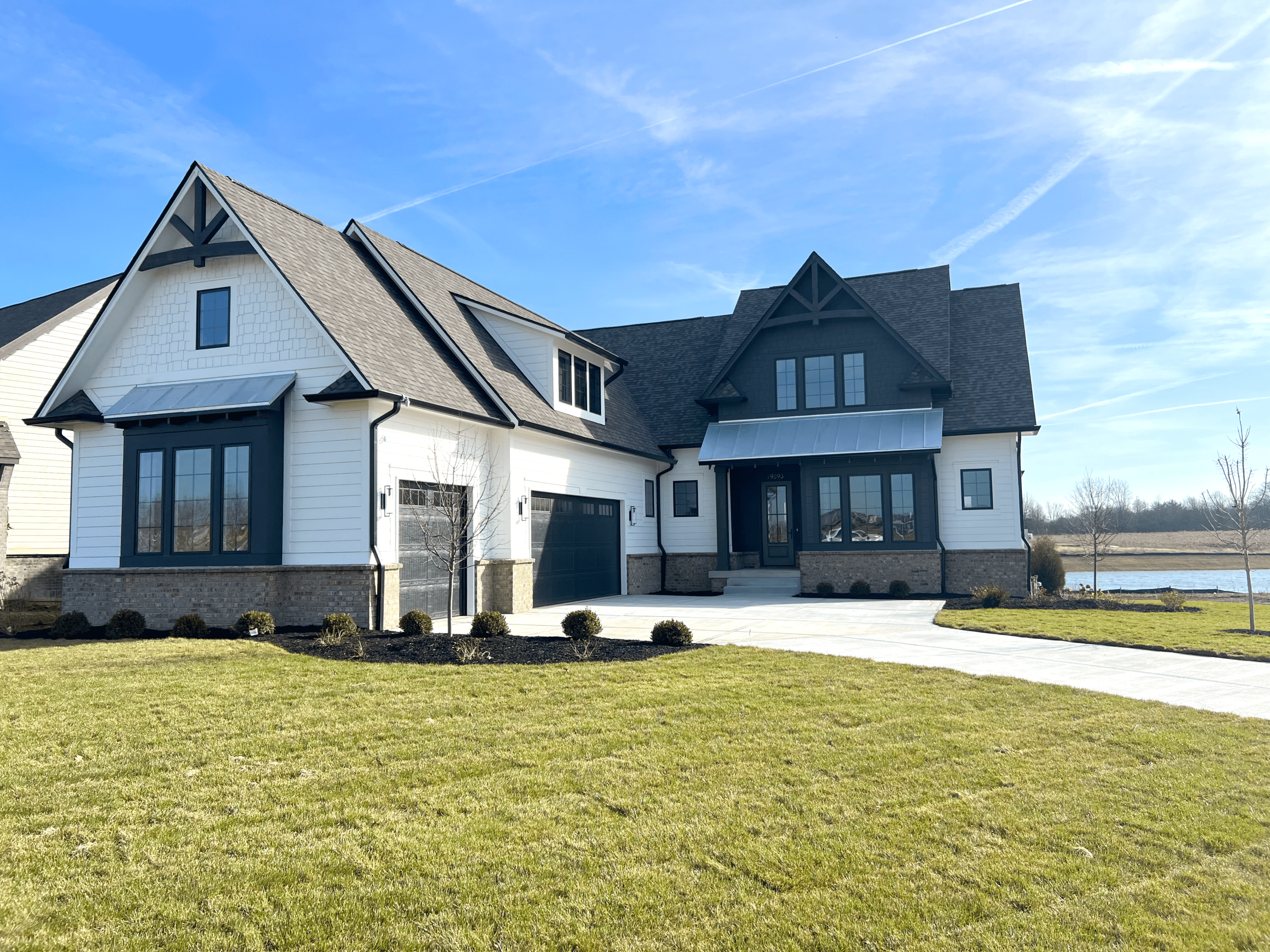 A custom home with a lake in the background, located in Westfield Indiana.