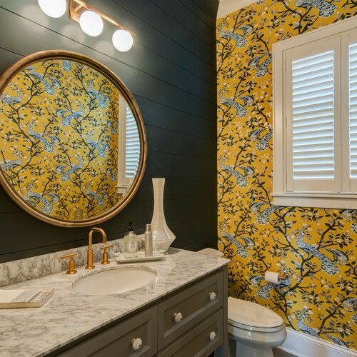 A bathroom with yellow and black floral wallpaper in a custom-built home in Carmel, Indiana.