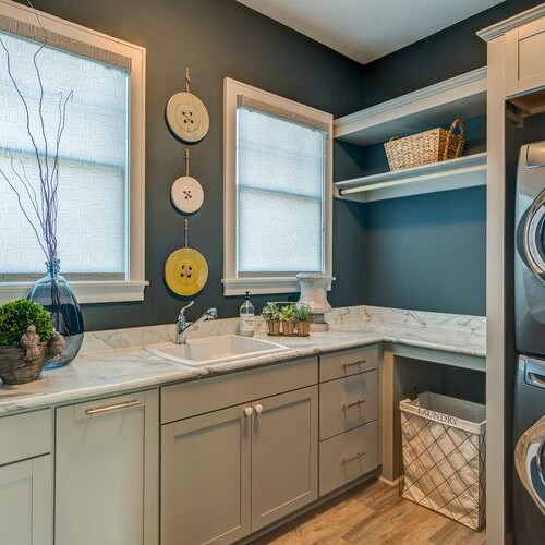 A laundry room with a washer and dryer in a new home for sale in Carmel, Indiana.