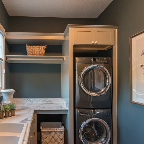 A laundry room equipped with a washer and dryer, available in custom homes for sale in Westfield, Indiana.