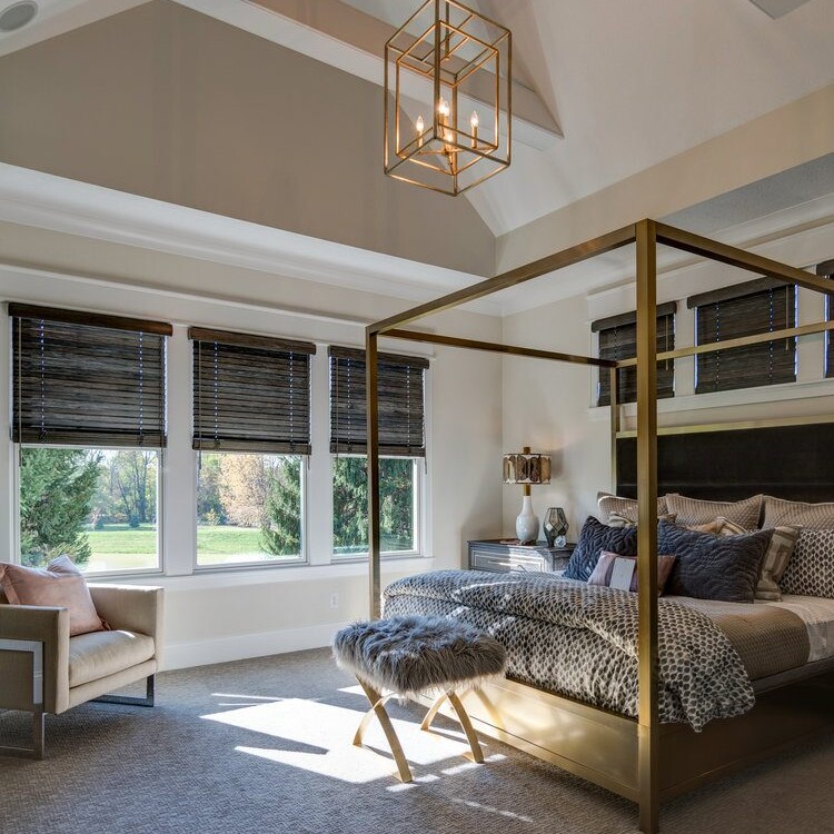 A custom bedroom with a four poster bed and a chandelier.