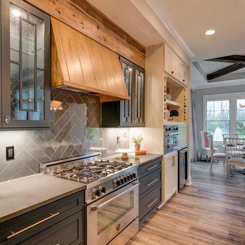 A kitchen with wood cabinets and stainless steel appliances in a new home construction in Indianapolis, Indiana.