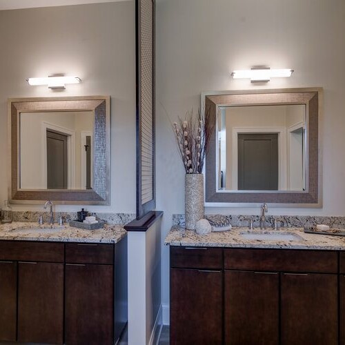 A bathroom with two sinks and mirrors in a new home construction in Indianapolis, Indiana.