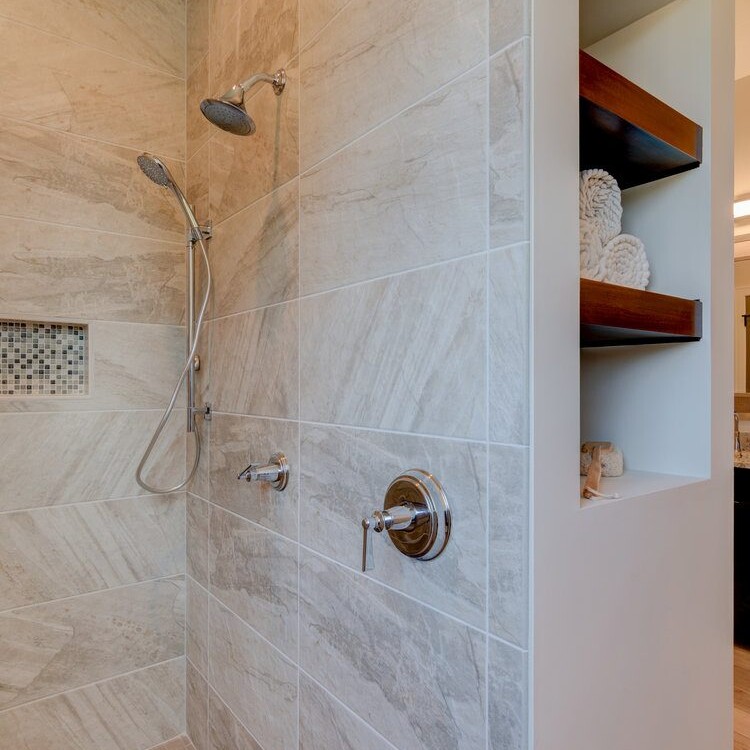 A bathroom with a walk in shower and a towel rack, perfect for new home construction or custom homes in Carmel, Indiana.