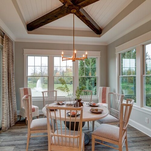 A dining room with wood beams and a table in a new home construction in Indianapolis, Indiana.