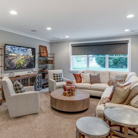 A living room with couches, a coffee table and a TV in a new home construction in Carmel, Indiana.