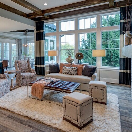 A living room with hardwood floors and a fireplace, ideal for homes for sale westfield in or new home construction indianapolis.