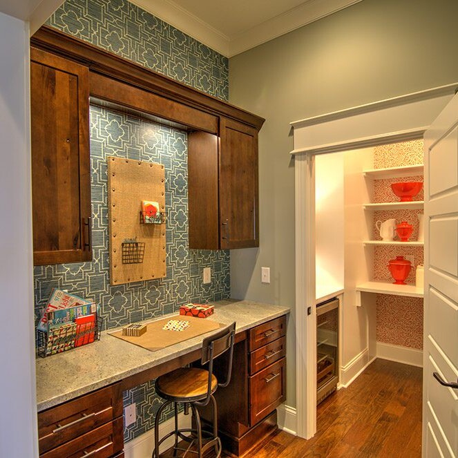 A small kitchen with a counter and cabinets, designed by a luxury custom home builder in Westfield Indiana.