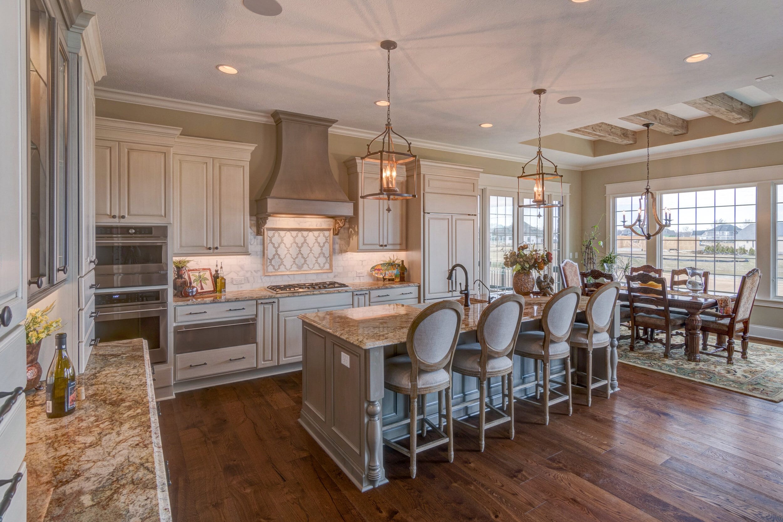 A large kitchen with hardwood floors and a center island is an attractive feature when considering new homes in the Custom Homes Westfield Indiana or Fishers Indiana areas. Whether you are looking for a custom home builder