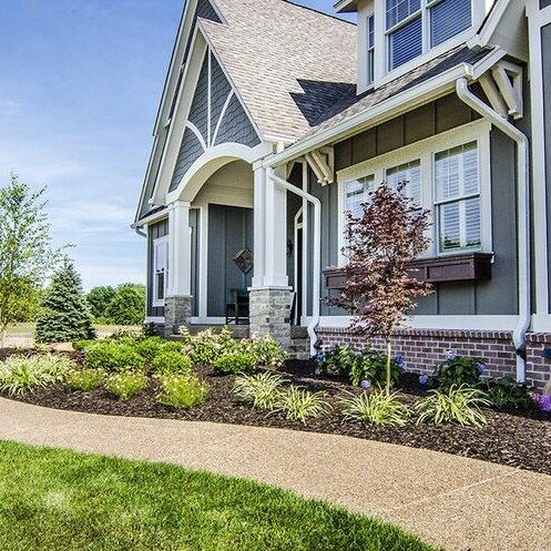 A new home with a large front yard and landscaping located in Carmel, Indiana.