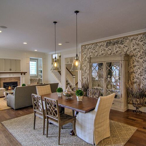 A luxurious dining room with hardwood floors and a cozy fireplace.