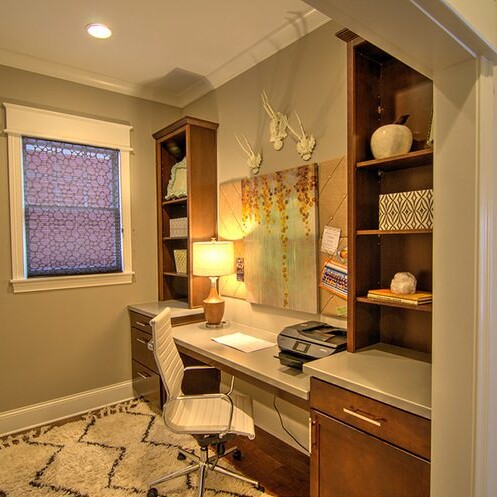 A meticulously designed home office with a desk and chair, crafted by a luxury custom home builder in Westfield Indiana.