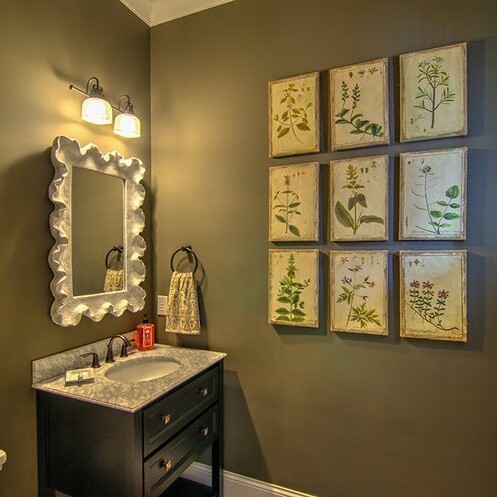 A bathroom with brown walls and framed pictures available in a luxury custom home built in Westfield, Indiana.