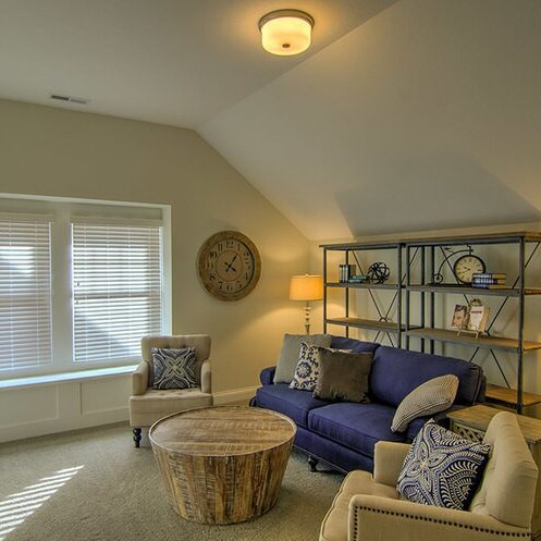 A living room with two couches and a coffee table in a luxury custom home.