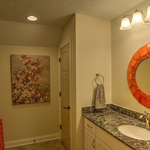 A bathroom with a mirror and a sink built by a custom home builder in Indianapolis Indiana.