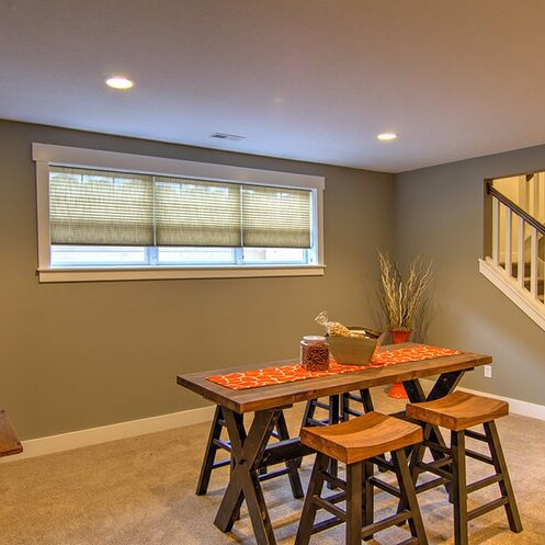 A room with a table and chairs, perfect for Fishers Indiana Custom Homes.