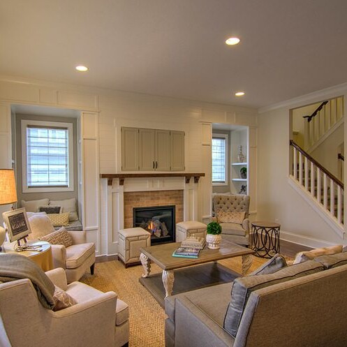 A luxurious living room with plush couches and a warm fireplace.