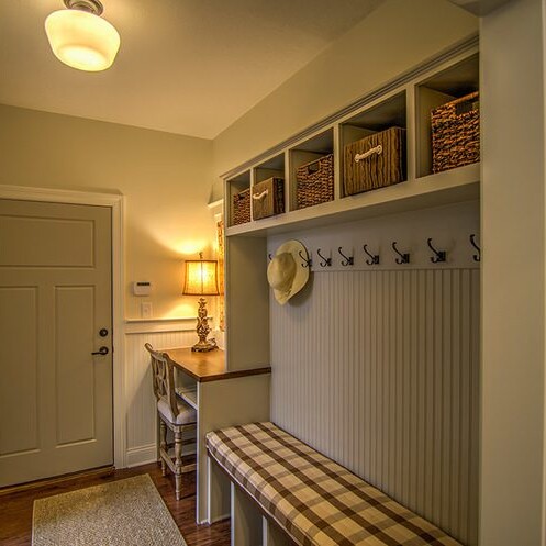 A hallway with a bench and baskets in a custom home.