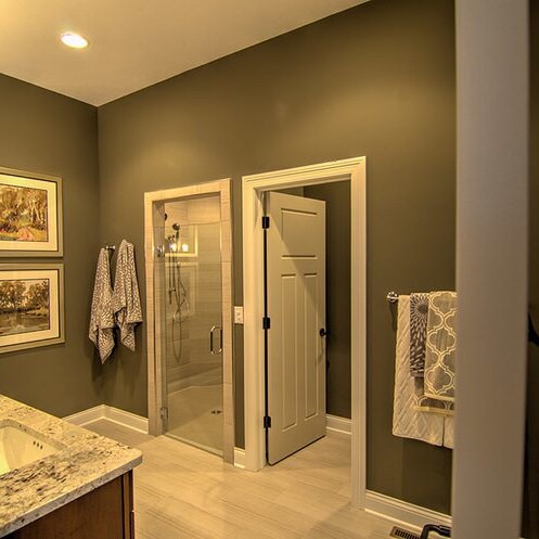 A bathroom with gray walls and a granite counter top in a custom home built by Fishers Indiana Custom Homes.