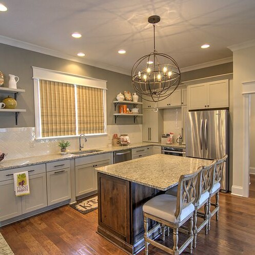 A kitchen with wood floors and a custom center island.