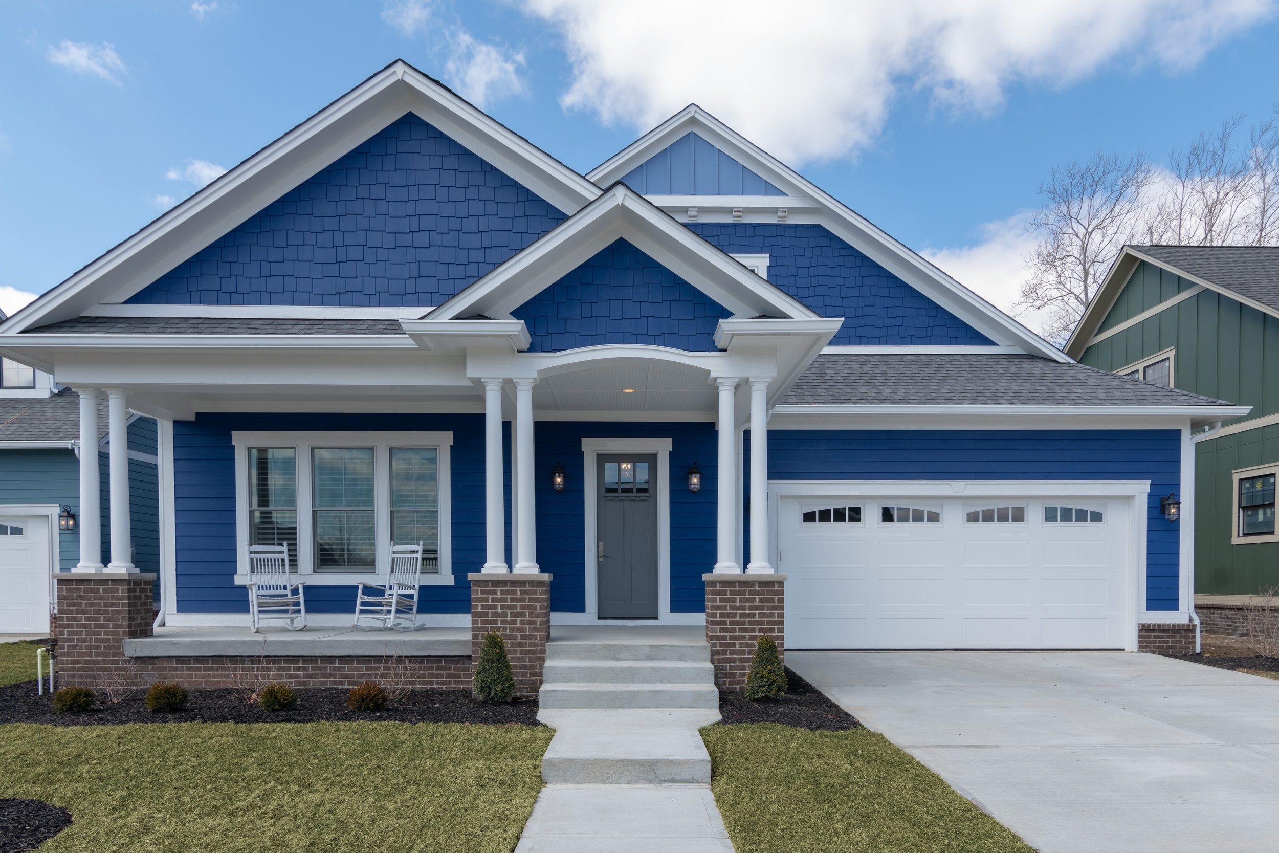 The exterior of a blue home with white trim built by a Custom Home Builder in Carmel Indiana.