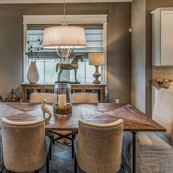 A kitchen with a dining table and chairs, designed by a luxury custom home builder in Westfield Indiana.