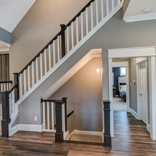 This new home for sale in Carmel Indiana features a staircase and stunning hardwood floors.